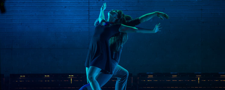 Student dancing with blue background